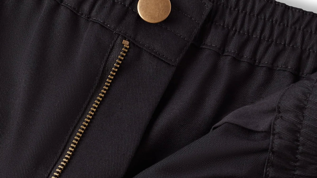 Chef trouser waistband showing the brass button and zip fly