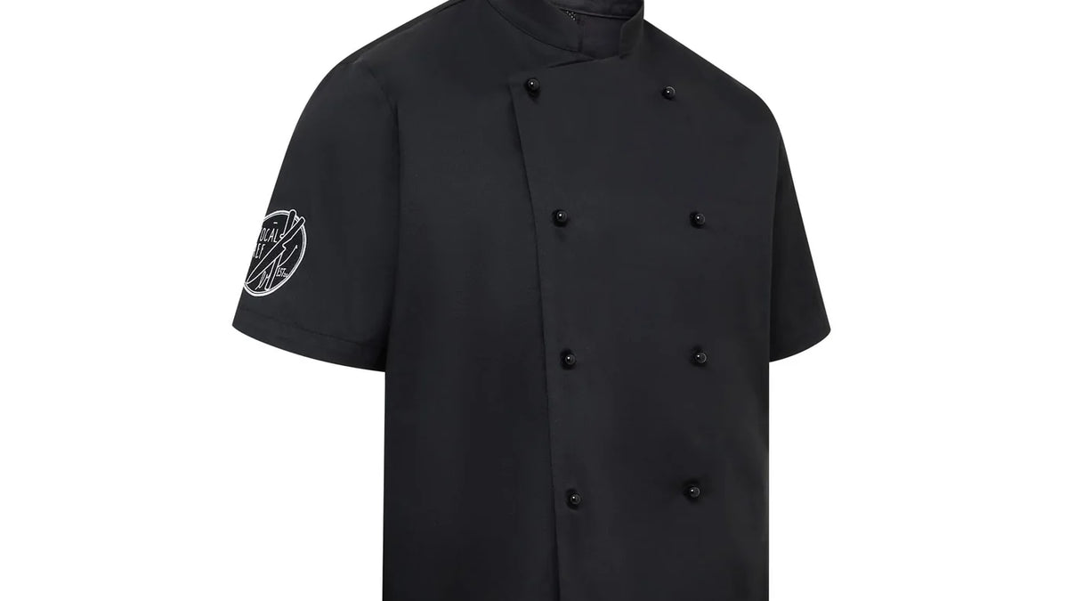 A black double-breasted chef jacket showing buttons and sleeve crest
